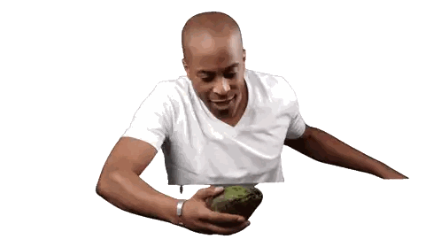 Man in White Shirt Holding Large Avocado