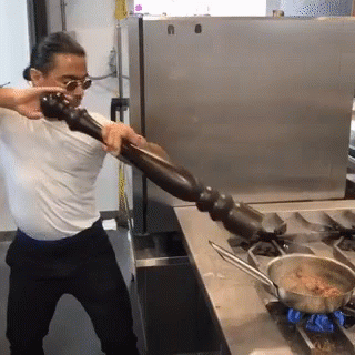 Man In White Shirt Holding Pepper Mill GIF