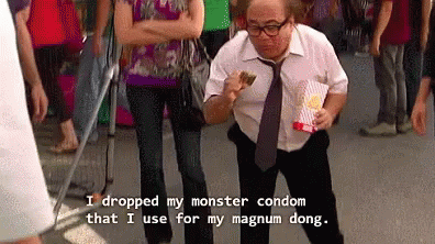 Man In White Shirt Holding Popcorn And Condom GIF