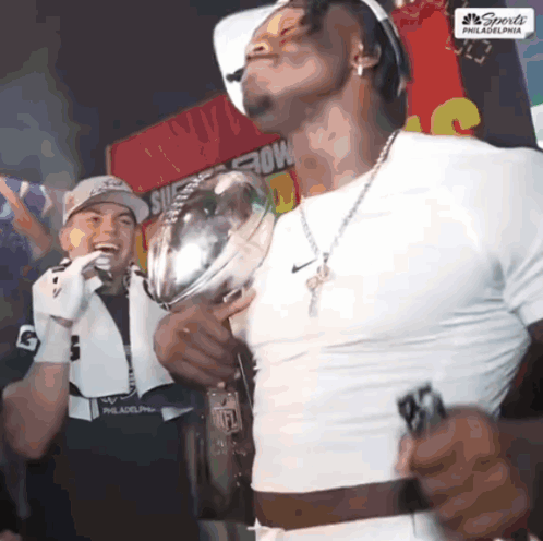 Man in White Shirt Holding Sports Trophy