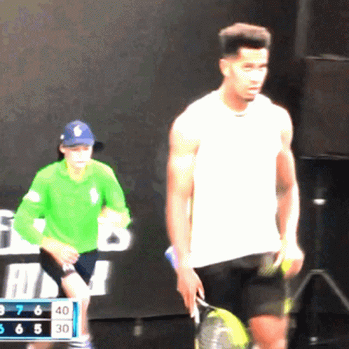 Man in White Shirt Holding Tennis Racquet