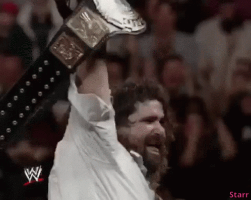 Man in White Shirt Holding Wrestling Belt