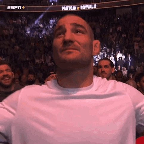Man in White Shirt in Front of ESPN Banner