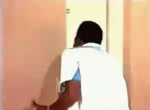 Man In White Shirt In Front Of Pink Wall GIF