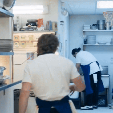 Man in White Shirt in Front of Refrigerator