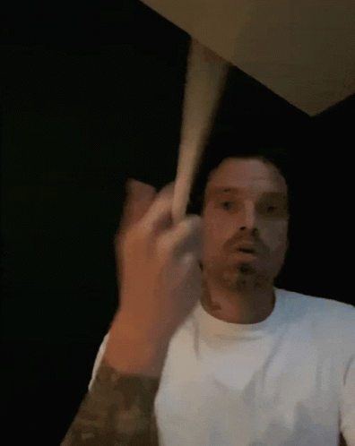 Man in White Shirt Making Face with Hand