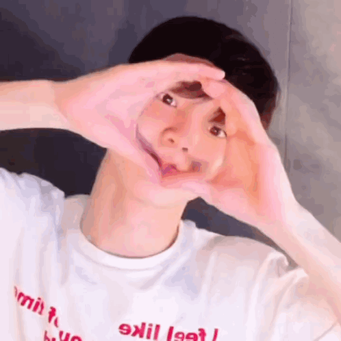 Man in White Shirt Making Heart