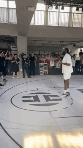 Man in White Shirt on Basketball Court