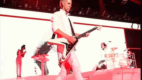 Man in White Shirt Playing Guitar