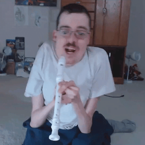 Man In White Shirt Playing Recorder With Mustache GIF