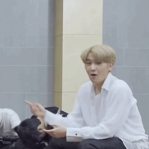 Man in White Shirt Pointing at Another Man