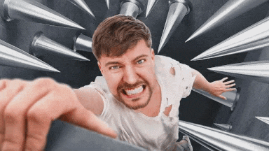 Man In White Shirt Pointing At Camera With Bullets GIF