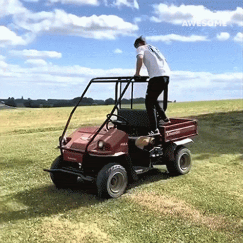 Man In White Shirt Riding Red Kawasaki Vehicle GIF