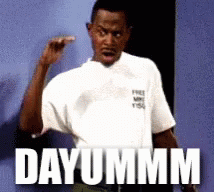 Man In White Shirt Saying Dayummm In Front Of Blue Wall GIF