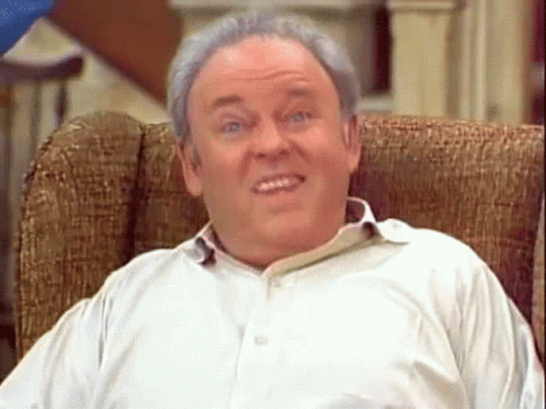 Man in White Shirt Sitting in Chair