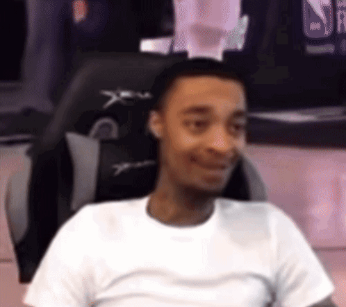 Man in White Shirt Sitting in Chair