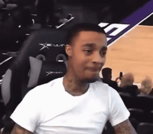 Man In White Shirt Sitting In Xenon Chair On Basketball Court GIF