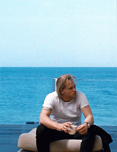 Man in White Shirt Sitting on Couch