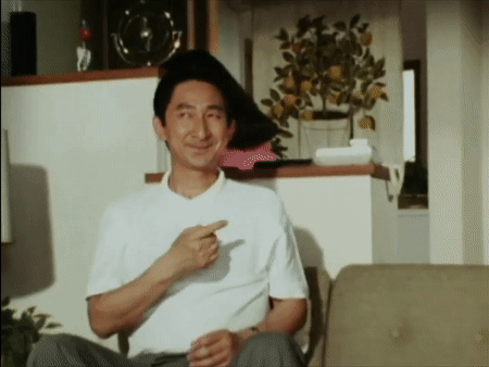 Man In White Shirt Sitting On Couch Pointing GIF