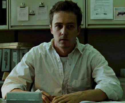 Man in White Shirt Sitting With Calculator