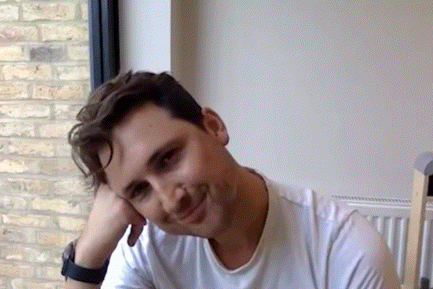 Man in White Shirt Smiling With Hand On Face