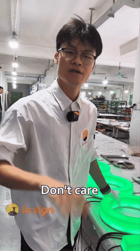 Man in White Shirt Standing Before Do Not Care Sign