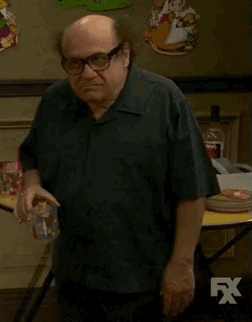 Man In White Shirt Standing By Couch And Star Wars Poster GIF