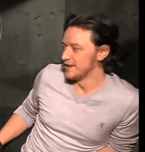 Man In White Shirt Standing In Dark Room GIF