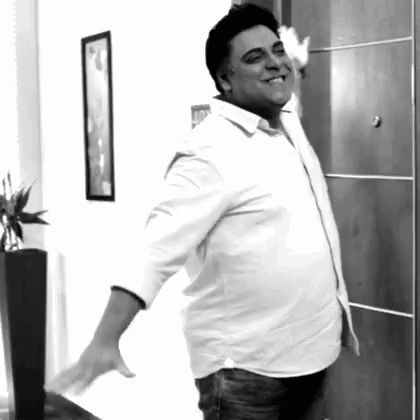 Man In White Shirt Standing In Front Of Door GIF