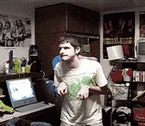 Man In White Shirt Standing In Front Of Laptop GIF