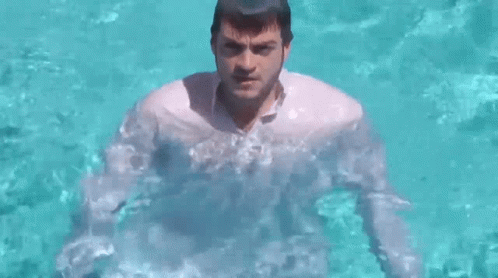 Man In White Shirt Standing In Water GIF