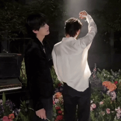 Man In White Shirt Standing Next To Man In Black Suit GIF