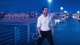Man In White Shirt Standing On Pier At Night GIF