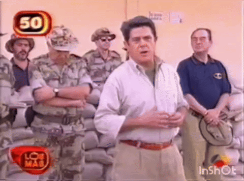 Man in White Shirt Talking to Soldiers