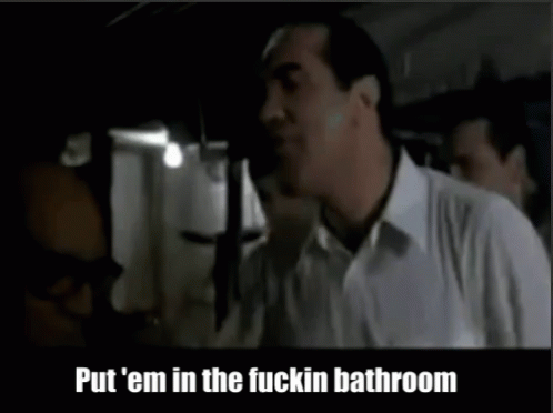 Man in White Shirt Telling Put Em in Bathroom
