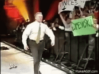Man In White Shirt Walking On Stage With Vince Sign GIF