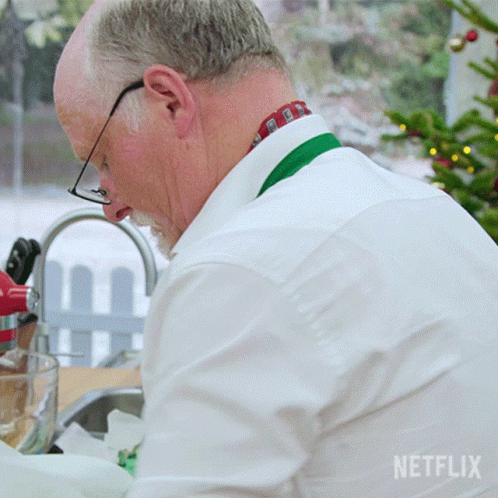 Man in White Shirt Washing Dishes with Netflix Logo