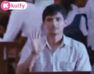 Man in White Shirt Waving in Classroom