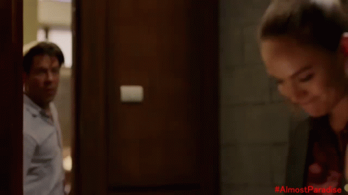 Man In White Shirt With #AlmostParadise In Red GIF