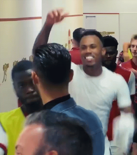 Man in White Shirt with Arm Raised
