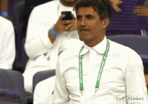 Man in White Shirt With Green Lanyard Saying Saudi Arabia