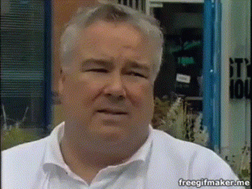 Man in White Shirt with It's 100 Sign