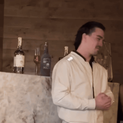 Man in White Shirt with Jack Daniels Bottles