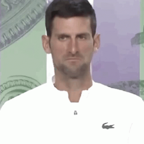 Man in White Shirt with Lacoste Logo Making Funny Face