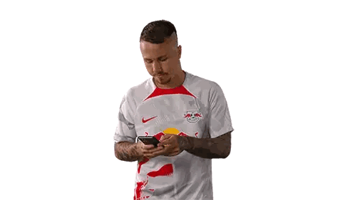 Man in White Shirt with Red Bull Talking on Phone