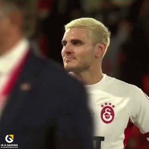 Man in White Shirt with Red G
