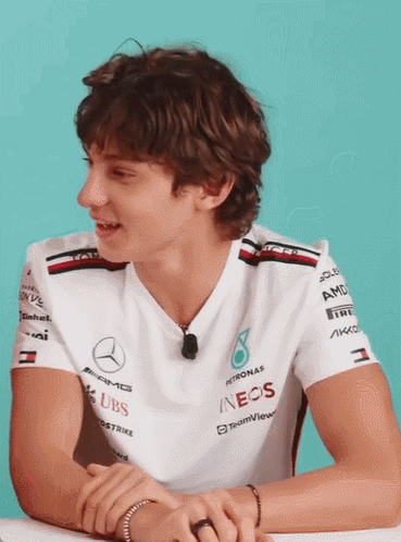 Man in White Shirt With Sleeve Sponsors