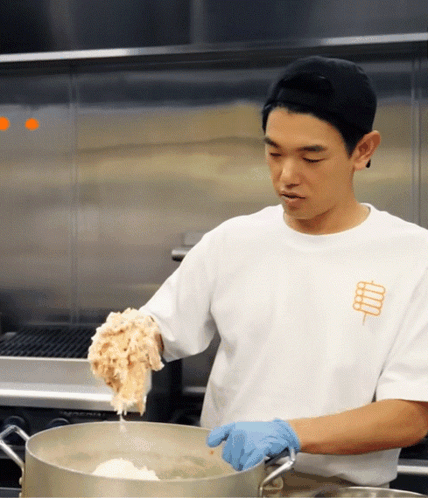 Man In White Shirt With Stick Cooking GIF