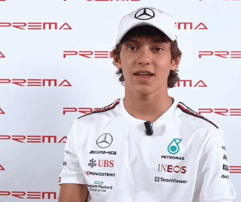 Man in White Shirt With UBS and INEOS Sponsors