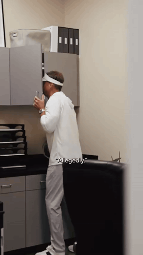 Man in White Shirt With Word Allegedly